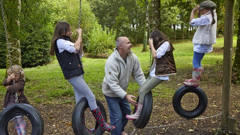 Family in the play area at Springhill, County Londonderry.